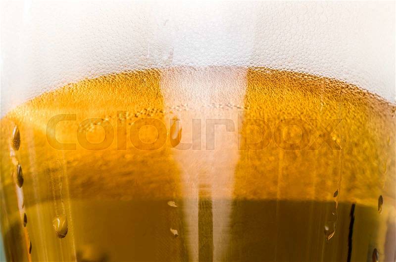 Light beer poured in a glass closeup, stock photo
