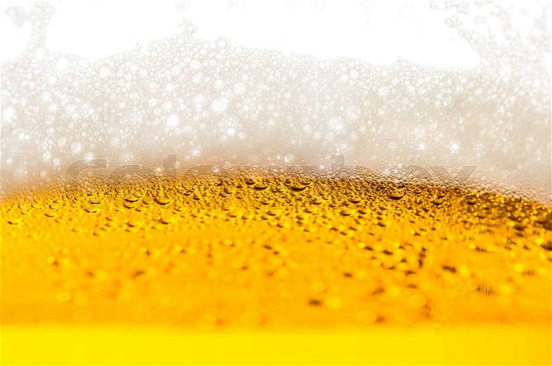 Light beer poured in a glass closeup, stock photo