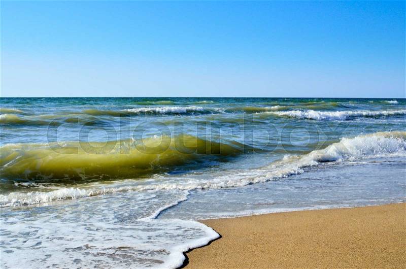 Tidal wave on a clean, sandy, sea beach, stock photo