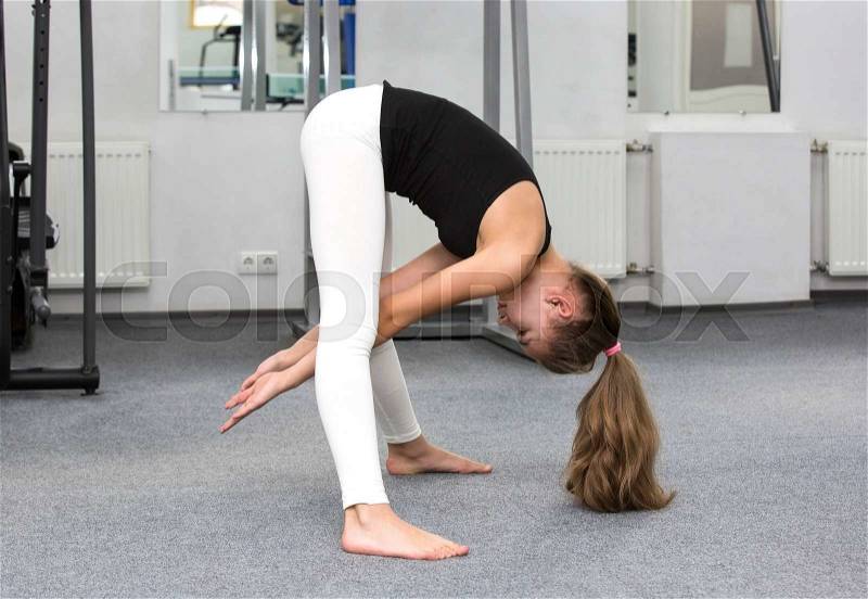 Girl is engaged in sports and gymnastics in the gym, stock photo
