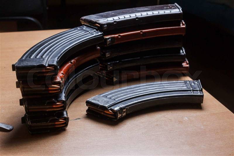 7.62 and 5.56 ammo for machine guns with loaded magazines 7.62 ammo for machine guns with loaded magazines on table, stock photo