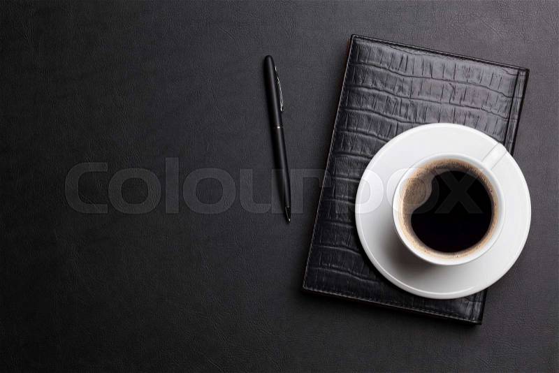 Office leather desk table with coffee cup, notepad and pen. Top view with copy space, stock photo