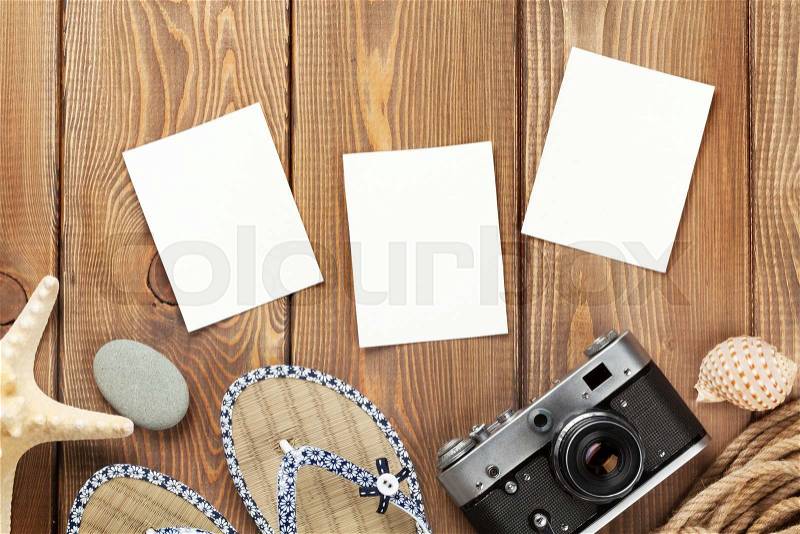 Travel and vacation photo frames and items on wooden table. Top view, stock photo