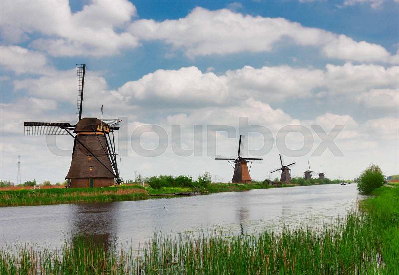 Dutch windmills reflecting in canal, Kinderdijk site, Holland, stock photo