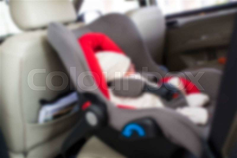 Blurry background Newborn baby boy sleeping in modern car seat. New born child traveling by car. Child safety on the road. Safe way to travel with young kids. Fastened seat belts in a vehicle, stock photo