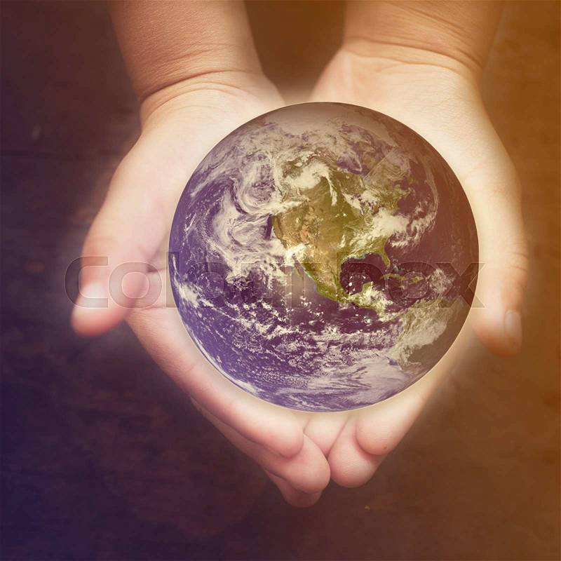 Child holding a glowing earth globe in his hands. Earth image provided by Nasa, stock photo