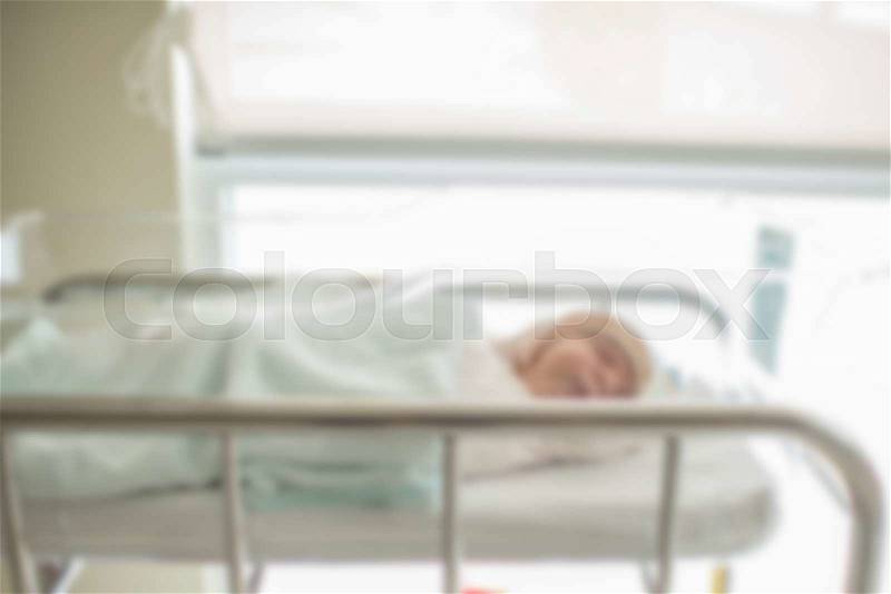 Blurry background Newborn baby in hospital post delivery room, stock photo