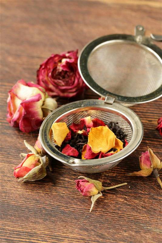Natural organic tea from dry roses on a wooden background, stock photo