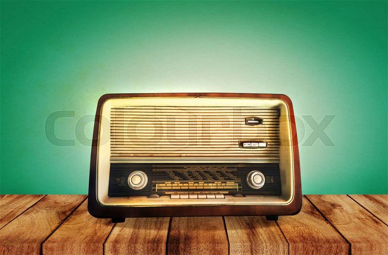Retro radio on wooden table, vintage style effect, stock photo