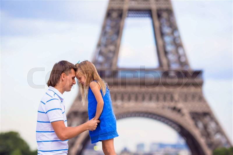 Happy dad and little adorable girl traveling in Paris near Eiffel Tower, stock photo
