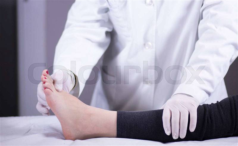 Traumatology and orthopedics surgeon in doctor and patient orthopedic medical examination consultation of foot, ankle and toes in hospital clinic, stock photo