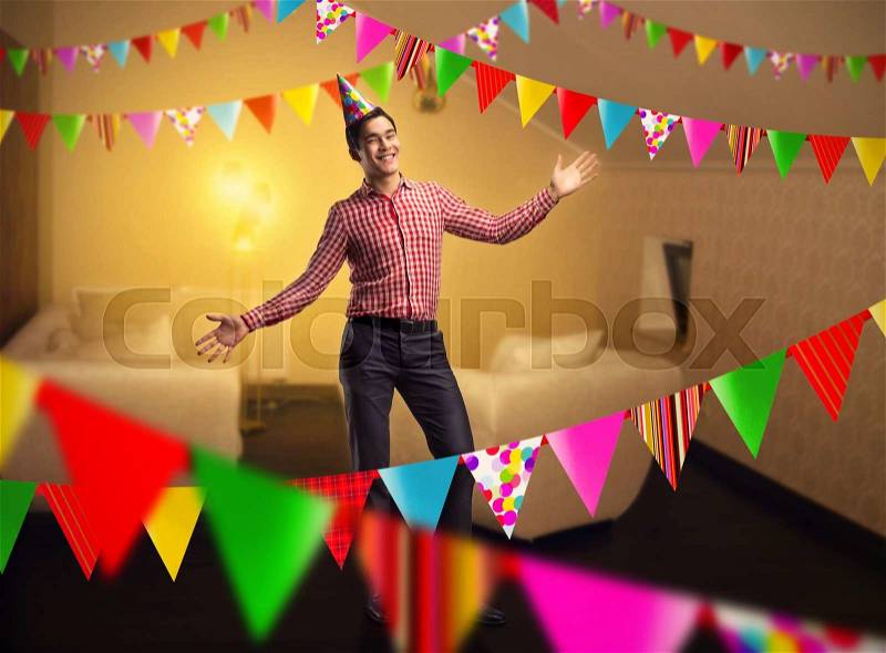 Happy birthday boy standing in decorated room, stock photo