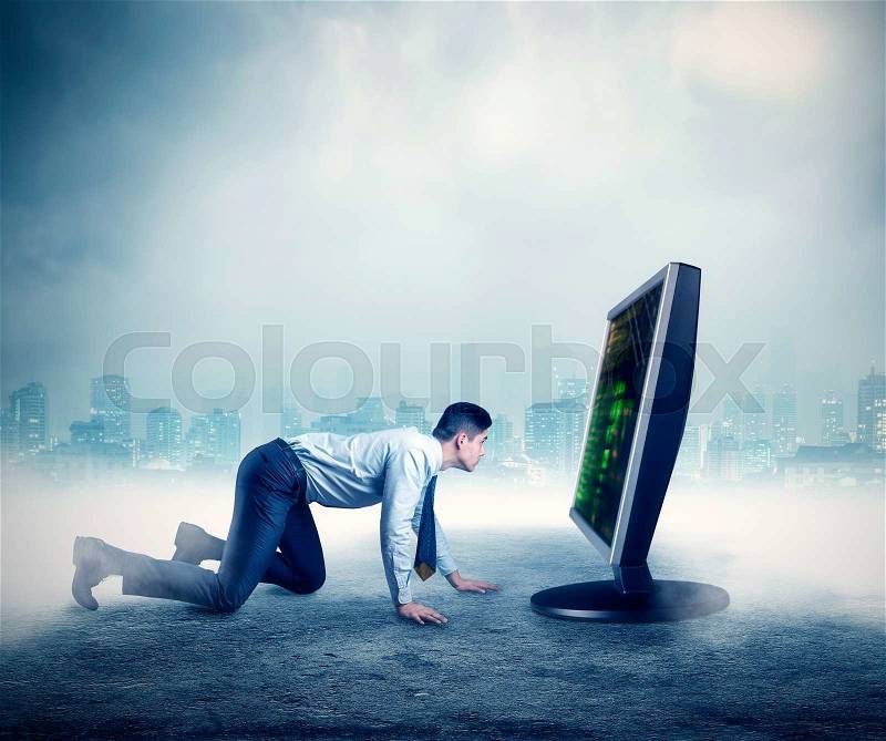 Businessman on all fours in front of the computer, stock photo