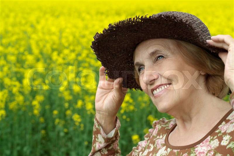 Portrait of a beautiful senior woman in field, stock photo