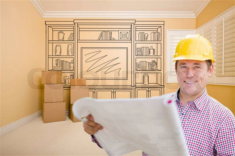 Male Construction Worker Wearing Hard Hat In Room With Drawing of Entertainment Unit On Wall, stock photo