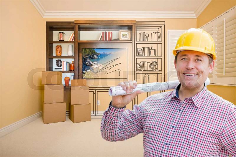Male Construction Worker Wearing Hard Hat In Room With Drawing of Entertainment Unit On Wall, stock photo