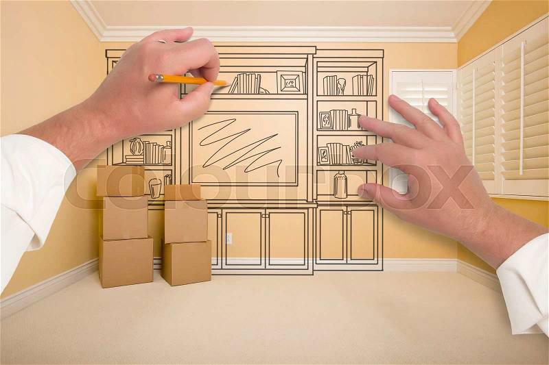Hands Drawing Beautiful Entertainment Unit In Room With Moving Boxes, stock photo