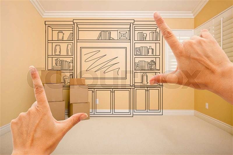 Hands Framing Drawing of Entertainment Unit In Empty Room With Moving Boxes, stock photo
