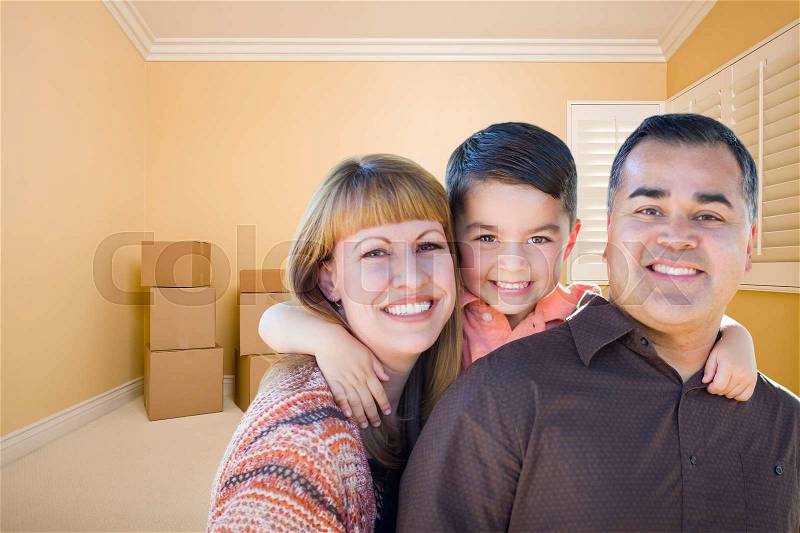 Happy Young Mixed Race Family In Room With Moving Boxes, stock photo