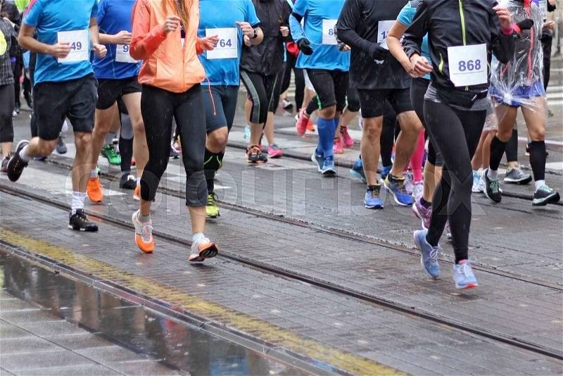 Unfocused Marathon running race in city streets, stock photo