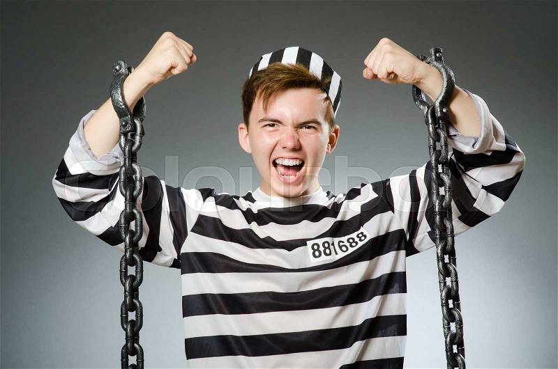 Funny prisoner in prison concept, stock photo