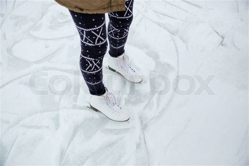 Closeup portrait of a female legs in ice skates, stock photo