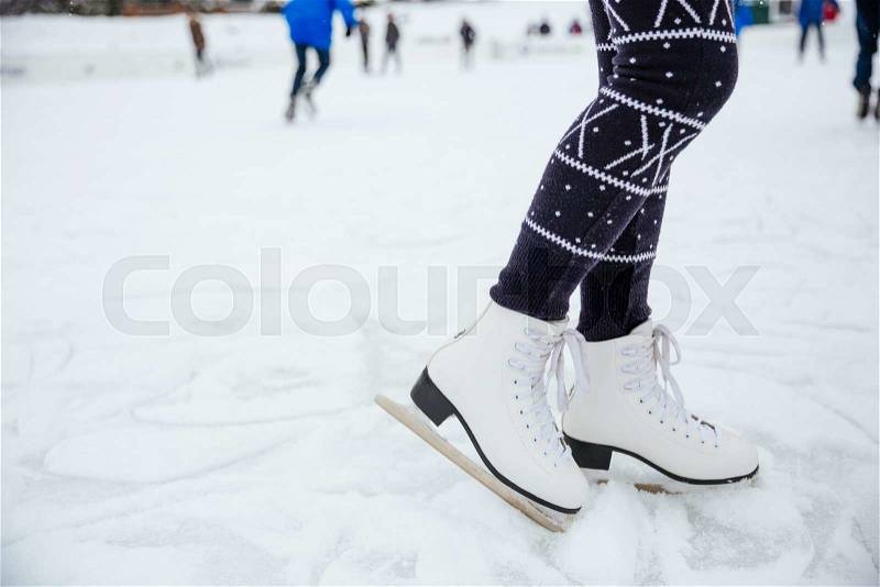Closeup portrait of a female legs in ice skates, stock photo