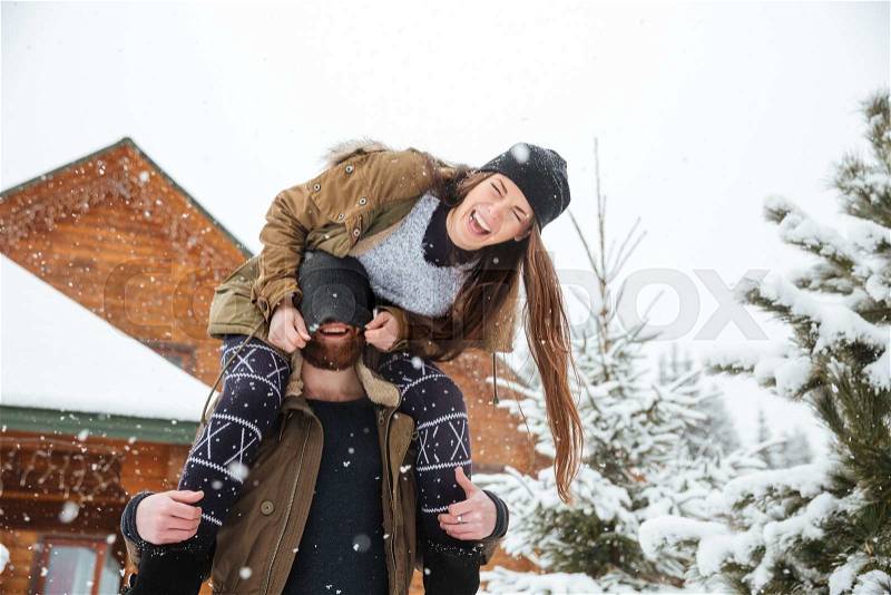 Happy young couple having fun and laughing in winter, stock photo