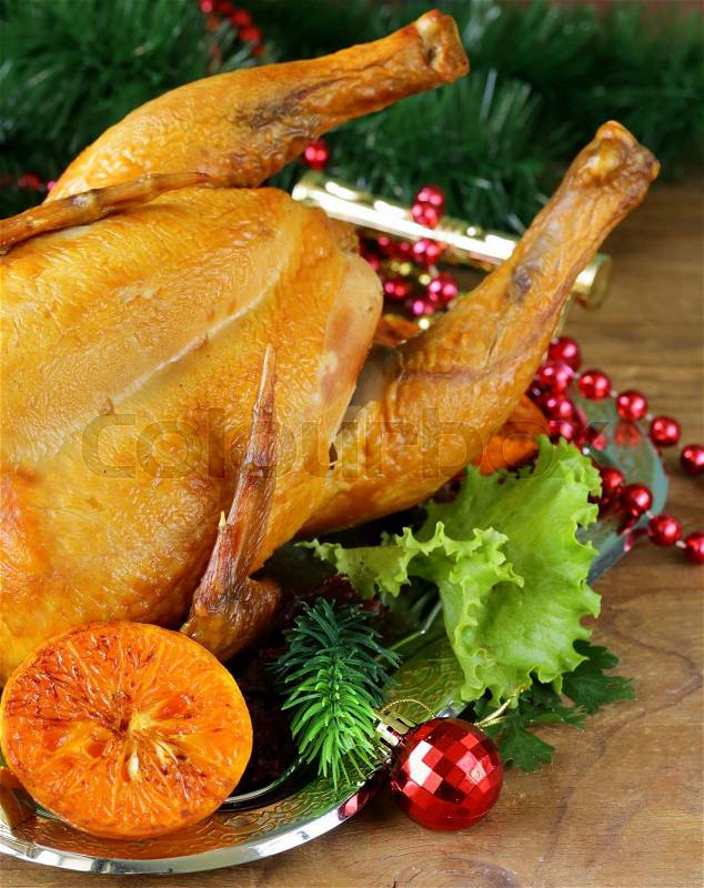 Baked chicken for festive dinner, Christmas table setting, stock photo