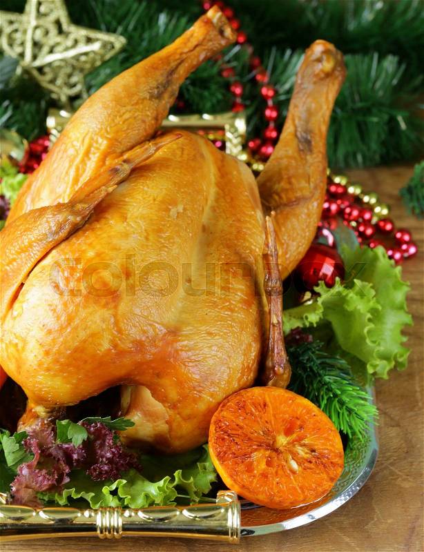 Baked chicken for festive dinner, Christmas table setting, stock photo