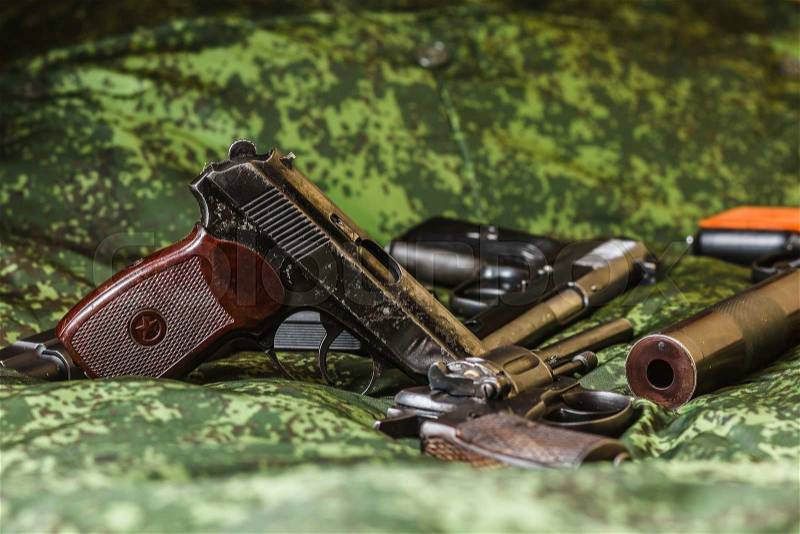 Weathered generic russian soviet semi-automatic 9mm pistols on pixel camouflage background, stock photo