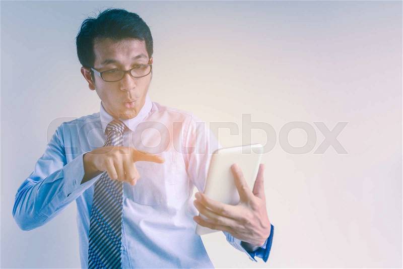 Businessman exciting and pointing to tablet, stock photo
