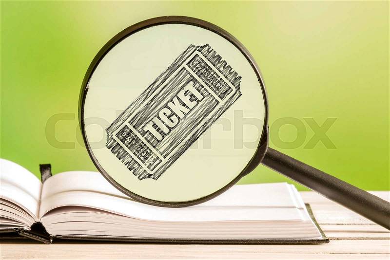 Ticket search with a pencil drawing of a ticket icon in a magnifying glass, stock photo