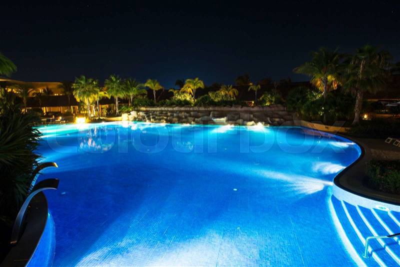 Swimming pool in night illumination, stock photo