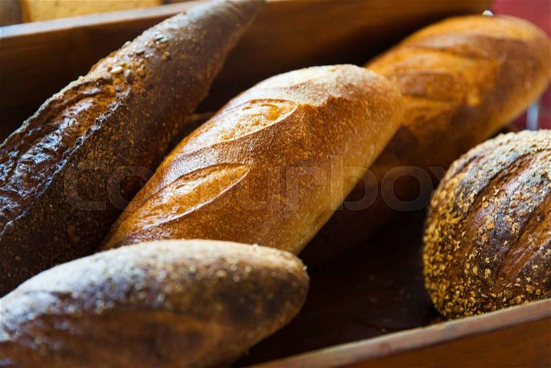 Food, baking, junk-food and unhealthy eating concept - close up of bread loafs at bakery, stock photo