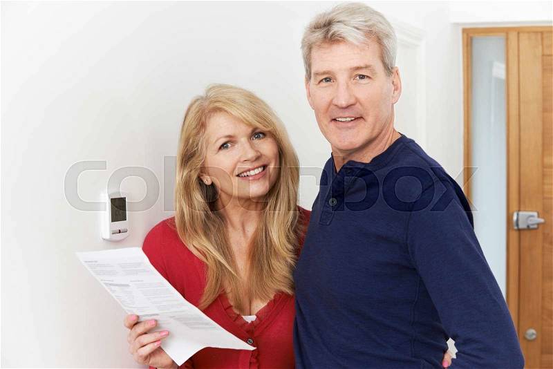 Mature Couple Saving Money On Domestic Heating Bills, stock photo