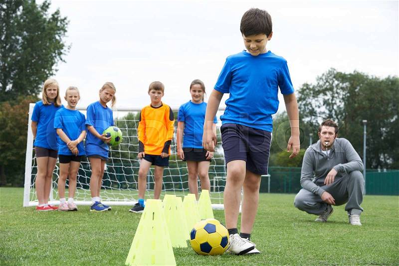 Coach Leading Outdoor Soccer Training Session, stock photo