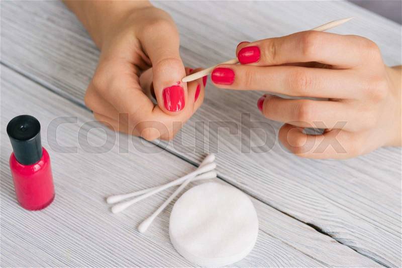 Woman\'s hands clean the skin from the nail varnish, stock photo