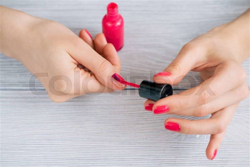 Women\'s hands painted nails with red lacquer, close-up, stock photo