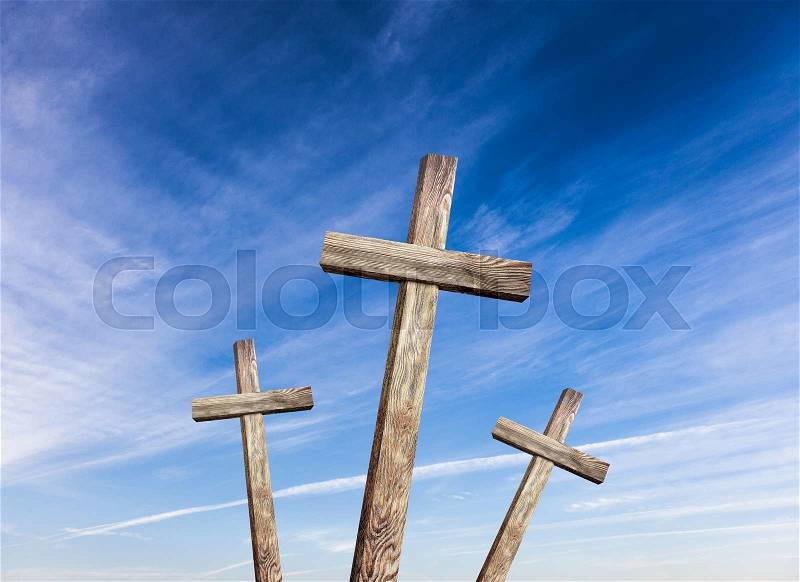 Old wooden cross on blue sky background, stock photo