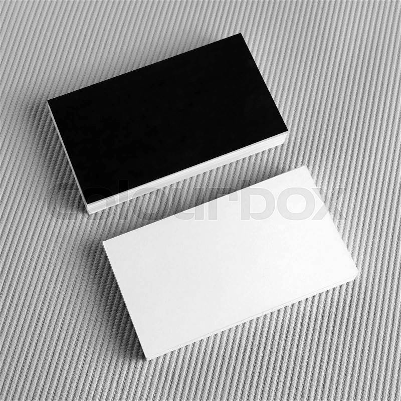 Photo of blank black and white business cards on gray background. Blank template for design presentations and portfolios. Mockup for branding identity, stock photo