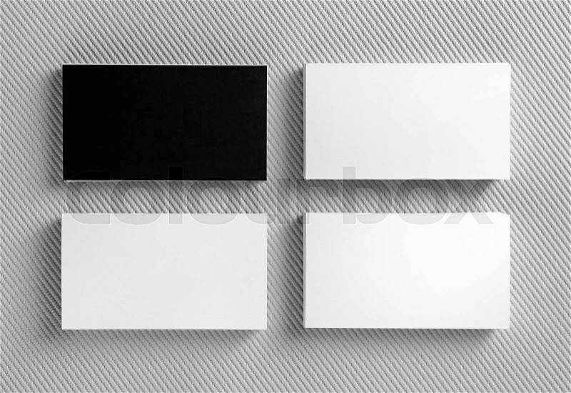 Blank black and white business cards on gray background. Mockup for branding identity. Template for graphic designers portfolios. Top view, stock photo