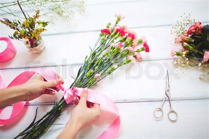 Close-up of florist making a bouquet, stock photo