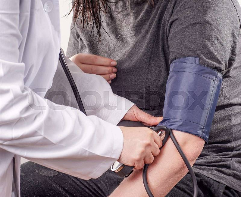 Patient gets Blood pressure check up by the Doctor, stock photo