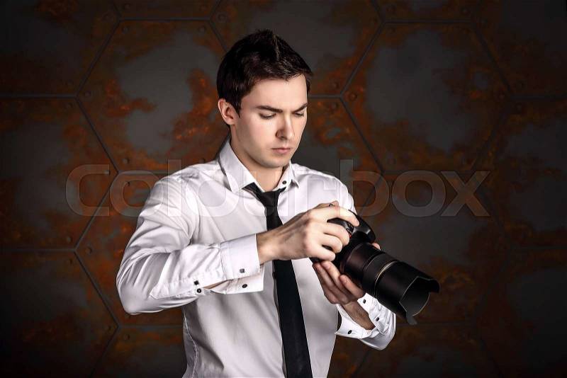 Professional photographer is changing settings in camera, stock photo