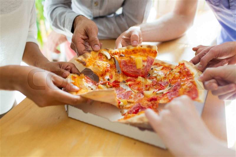 Food, lunch and people concept - close up of friends or people eating pizza, stock photo