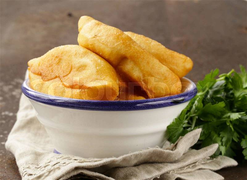 Homemade fried pies with potatoes, rustic style, stock photo