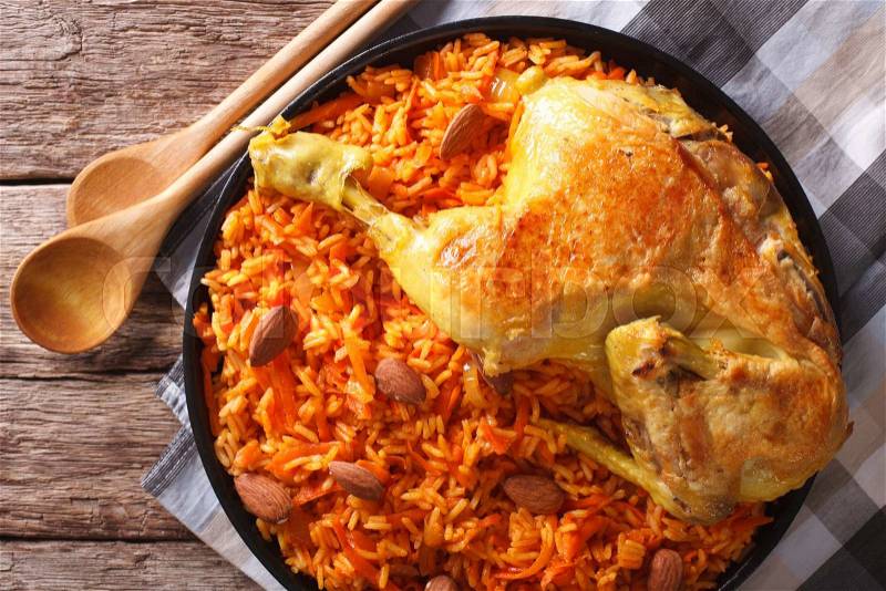 Arabic Food Kabsa: chicken with rice and vegetables close-up on a plate. horizontal view from above , stock photo