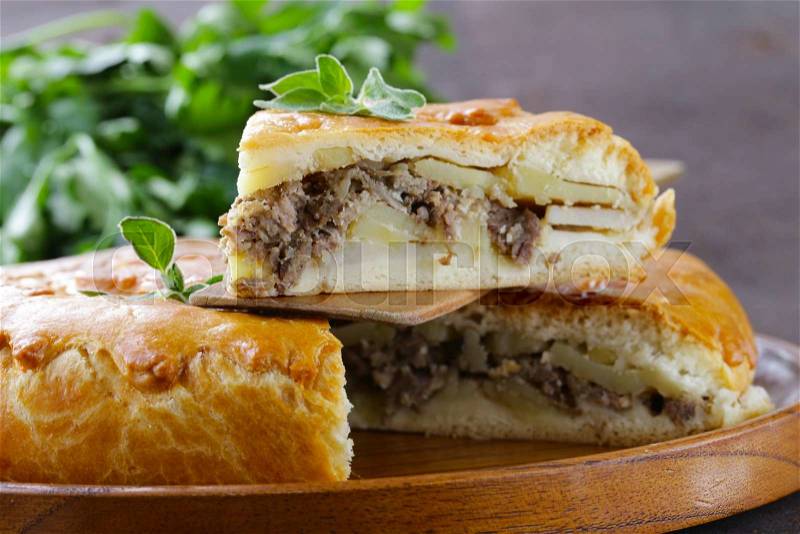 Homemade meat pie with potatoes and oregano, stock photo