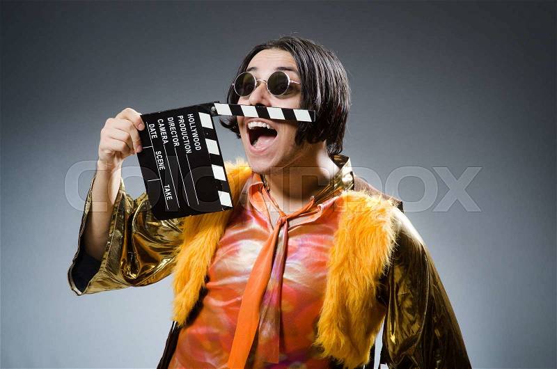 Young man with movie board, stock photo